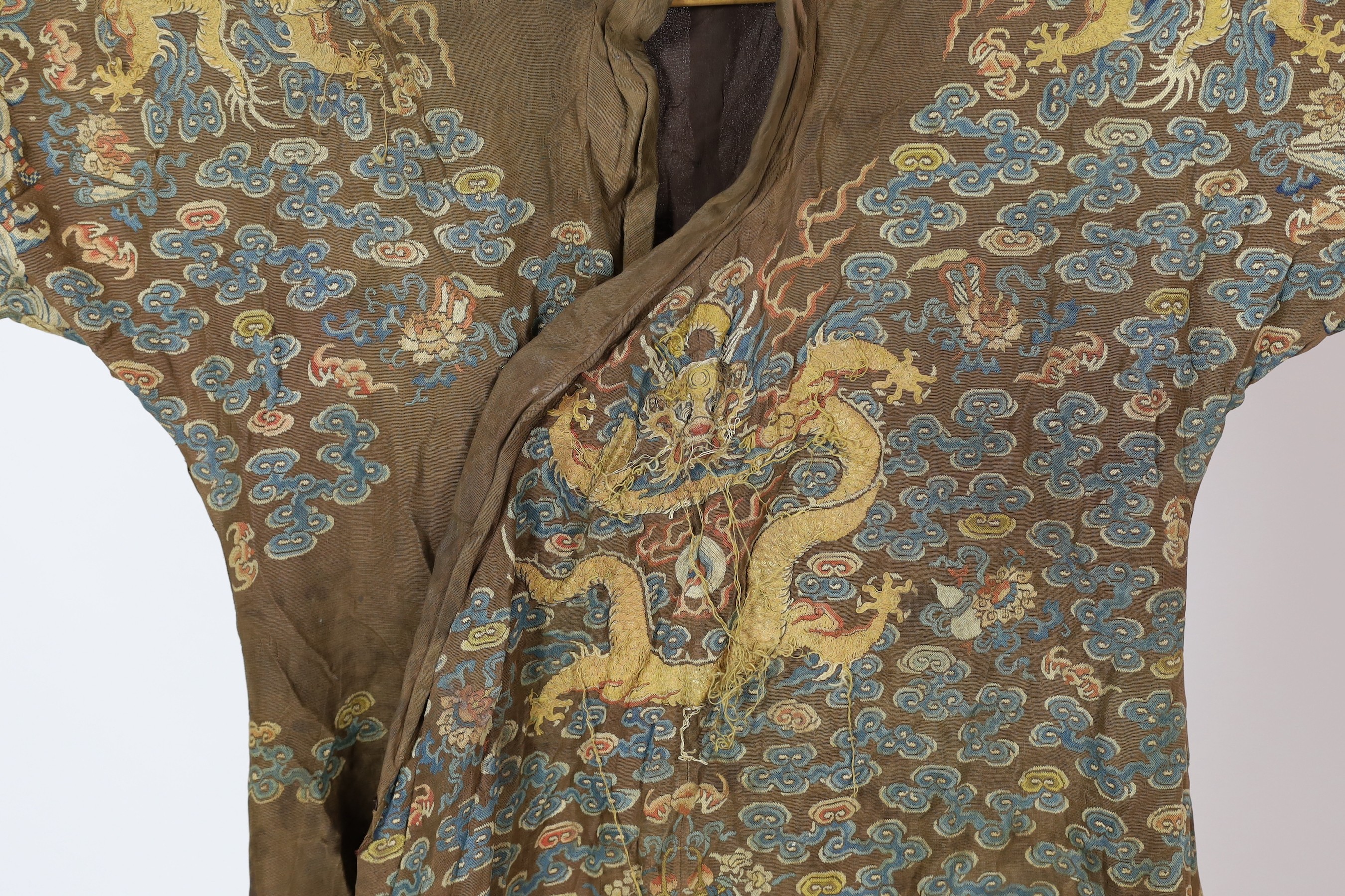 A Chinese embroidered silk and kesi gauze ’dragon’ summer robe, late Qing dynasty, some alterations and unpicked threads